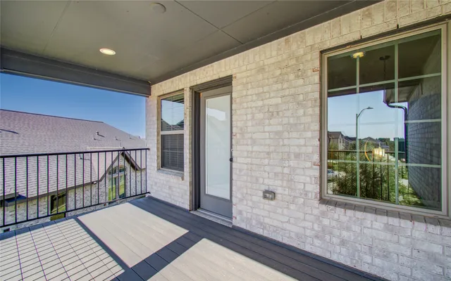 a view of a balcony with wooden floor