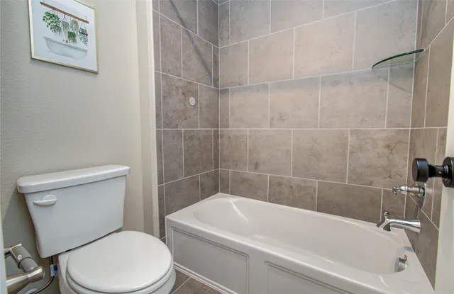 a white bath tub sitting next to a white toilet