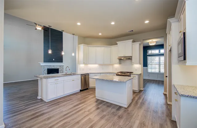 a kitchen with a stove a sink and a refrigerator