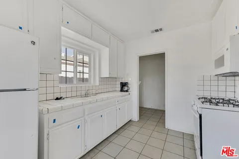 a spacious bathroom with a granite countertop sink a mirror and a