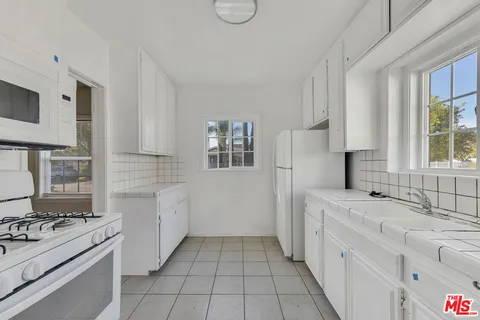 a kitchen with a sink stove and refrigerator