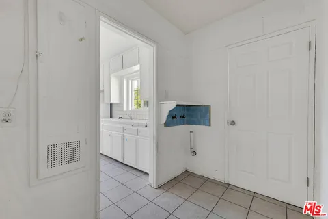 a view of a kitchen with white cabinets