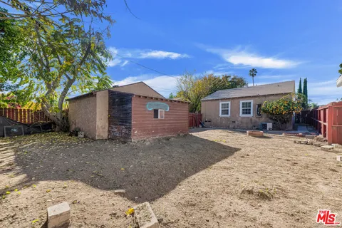 a view of a house with a yard and potted plants
