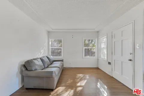 a living room with furniture and white walls