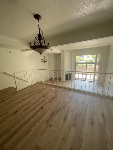 a view of a room with wooden floor