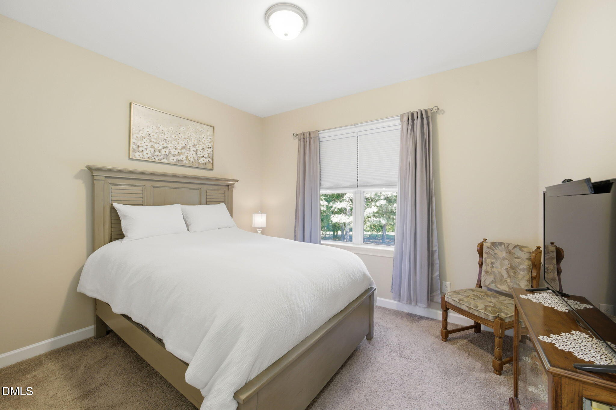 1547 Lassiter Pond Road Four Oaks, NC 27524 - Photo 24 of 45 a bedroom with a bed chair and window