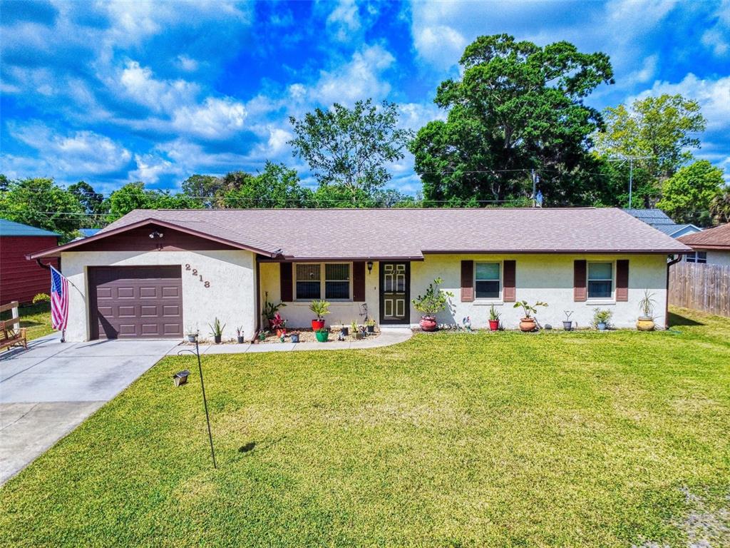 a view of a house with a yard porch and sitting area