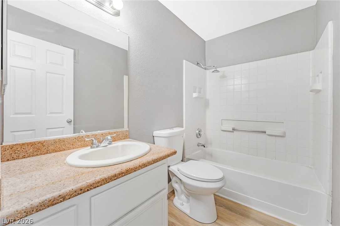 3318 North Decatur Boulevard, Unit 2152 Las Vegas, NV 89130 - Photo 26 of 58 Functional full bathroom featuring a tub-shower combination, modern vanity, and a large mirror.