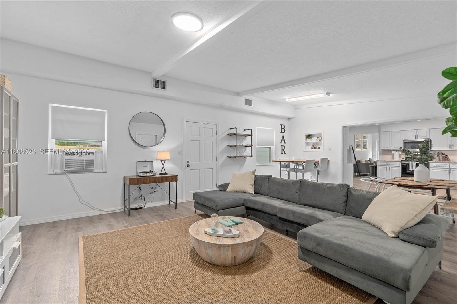 4255 Wee Street, Unit 4255 Mount Dora, FL 32757 - Photo 16 of 46 a living room with furniture a clock and a window