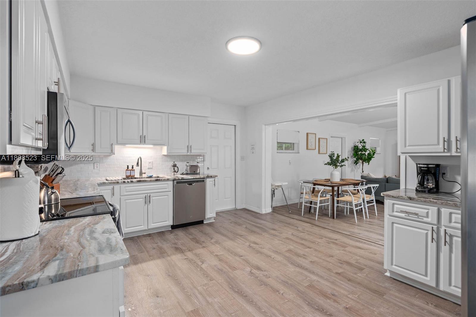 4255 Wee Street, Unit 4255 Mount Dora, FL 32757 - Photo 5 of 46 a kitchen with granite countertop a sink cabinets and stainless steel appliances