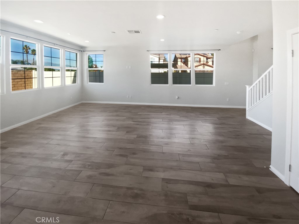 12420 Tesoro Court Grand Terrace, CA 92313 - Photo 18 of 43 an empty room with wooden floor and windows