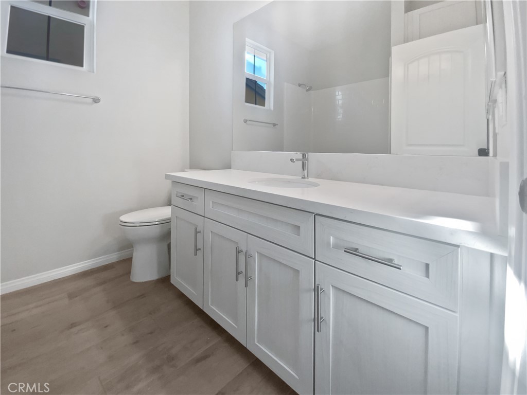 12420 Tesoro Court Grand Terrace, CA 92313 - Photo 27 of 43 a bathroom with a toilet sink and mirror
