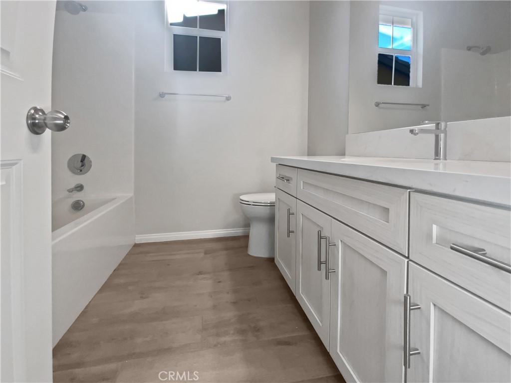 12420 Tesoro Court Grand Terrace, CA 92313 - Photo 28 of 43 a bathroom with a double vanity sink a toilet and shower