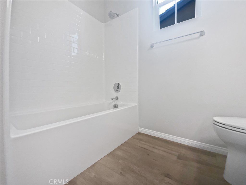 12420 Tesoro Court Grand Terrace, CA 92313 - Photo 29 of 43 a white bath tub sitting next to a white toilet