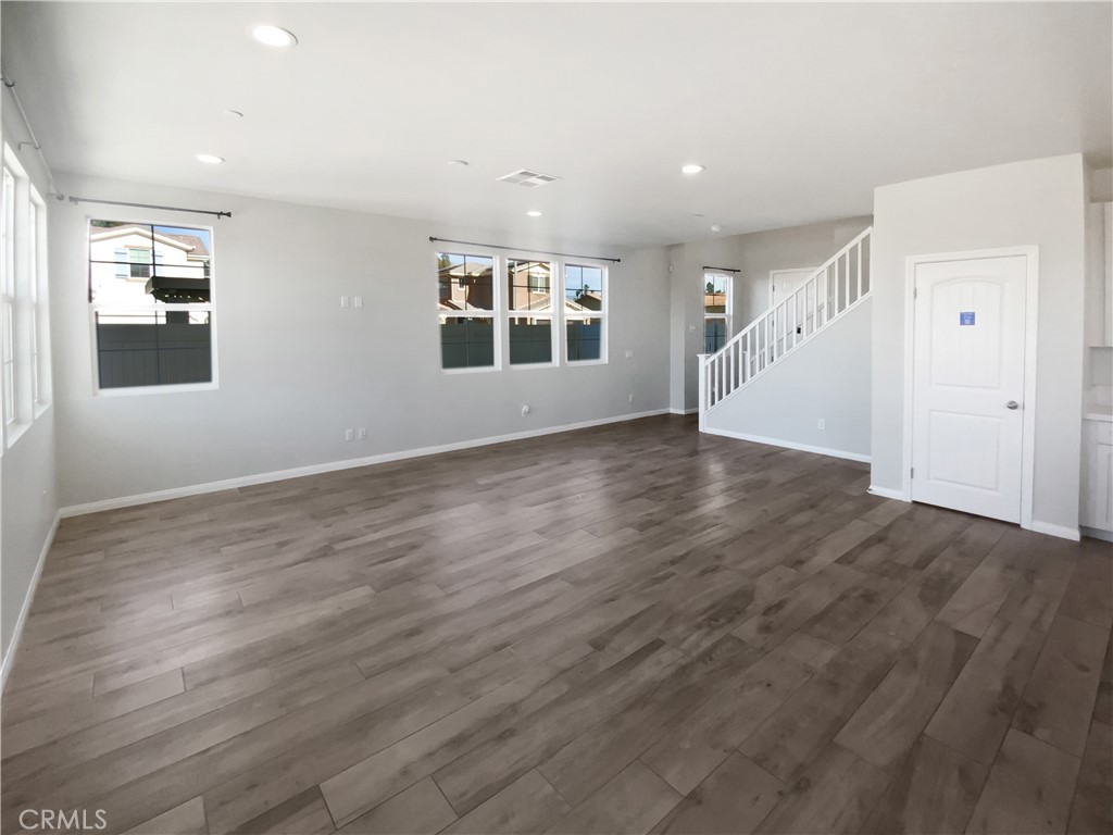 12420 Tesoro Court Grand Terrace, CA 92313 - Photo 3 of 43 an empty room with wooden floor and windows