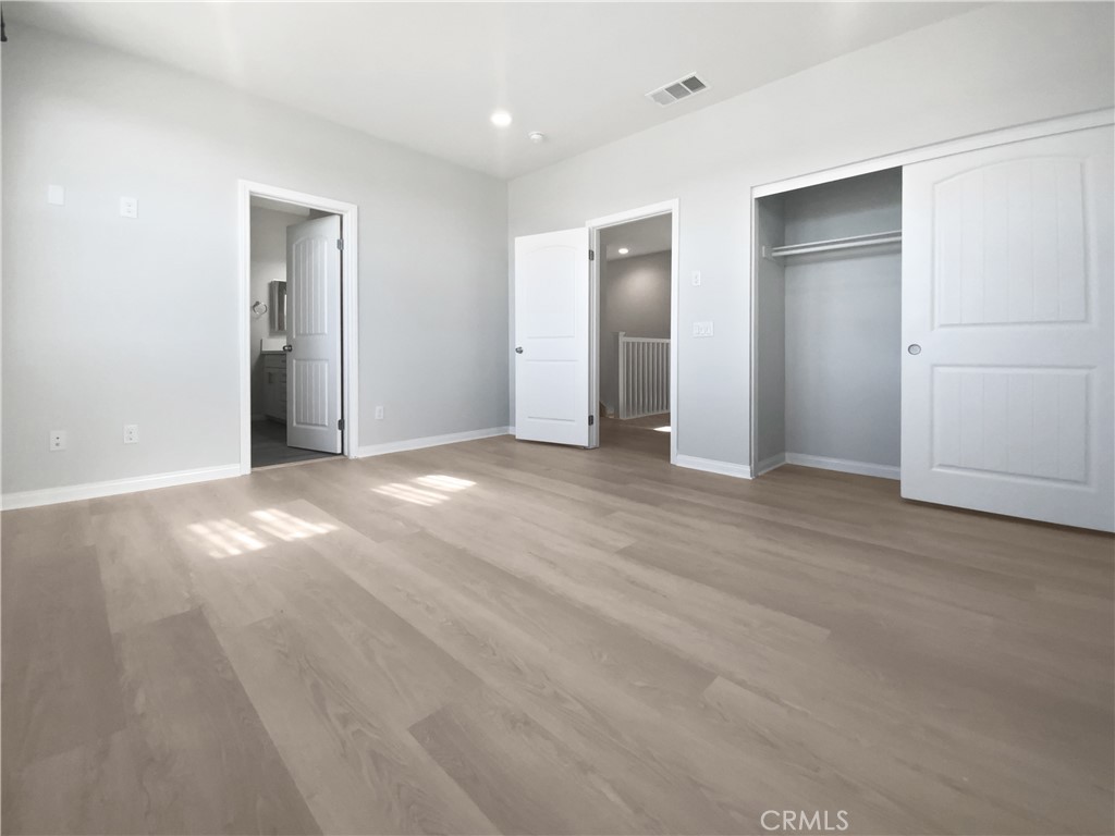 12420 Tesoro Court Grand Terrace, CA 92313 - Photo 31 of 43 an empty room with closet and windows