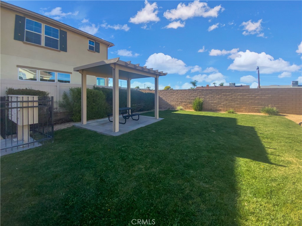 12420 Tesoro Court Grand Terrace, CA 92313 - Photo 40 of 43 a view of a backyard with floor to ceiling window and brick wall
