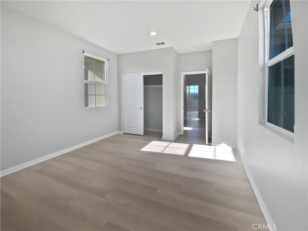 12420 Tesoro Court Grand Terrace, CA 92313 - Photo 4 of 43 a view of an empty room with wooden floor and a window
