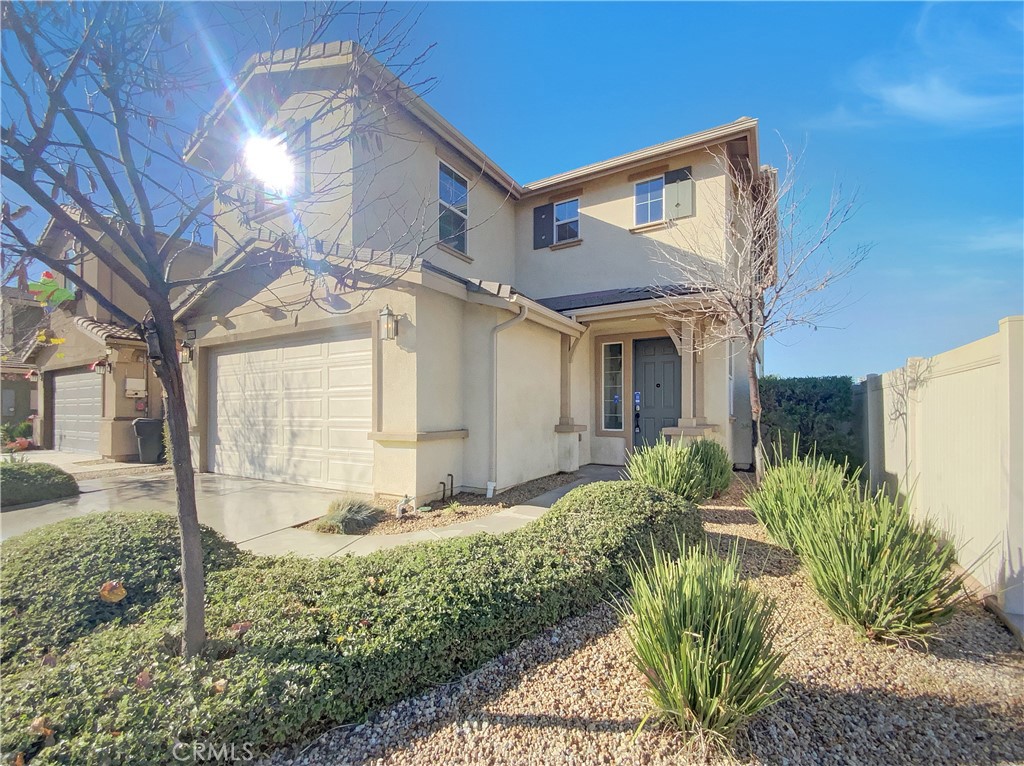 12420 Tesoro Court Grand Terrace, CA 92313 - Photo 7 of 43 a front view of a house with garden