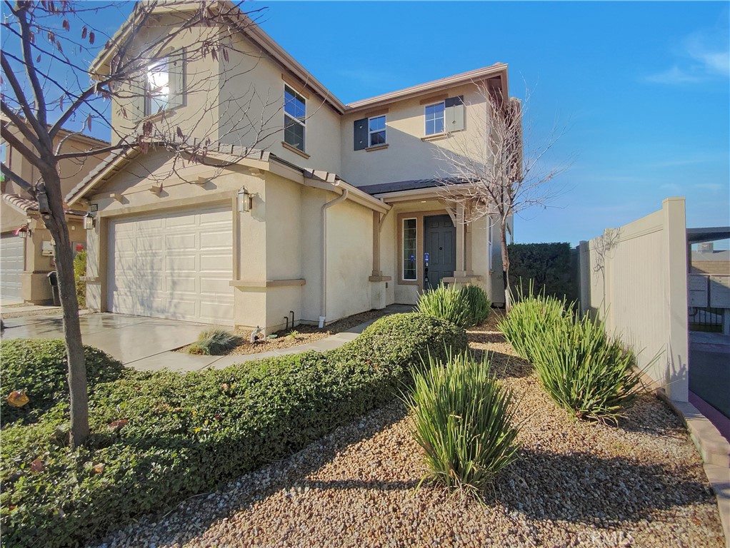 12420 Tesoro Court Grand Terrace, CA 92313 - Photo 9 of 43 a front view of a house with garden