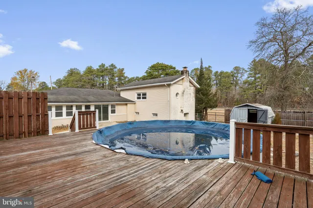 a view of house with backyard and deck