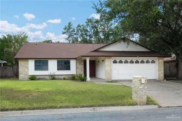 a view of a house with a yard and tree s