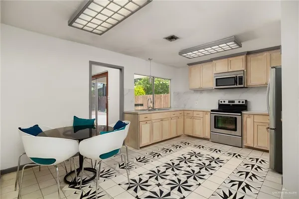 a kitchen with a stove a microwave and dining table