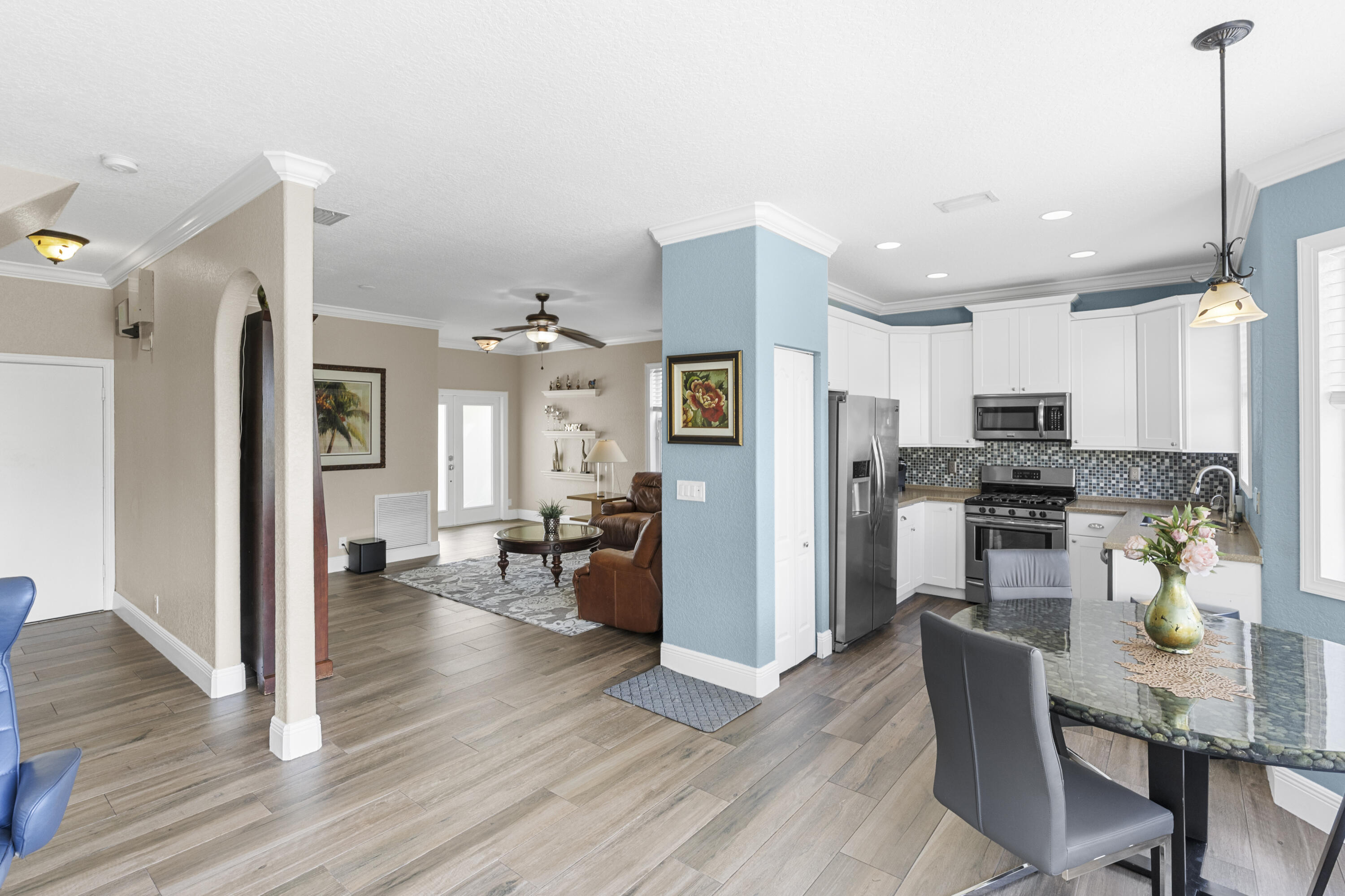 5791 Raceway Road Lake Worth, FL 33449 - Photo 13 of 62 a living room with stainless steel appliances furniture wooden floor and a view of kitchen