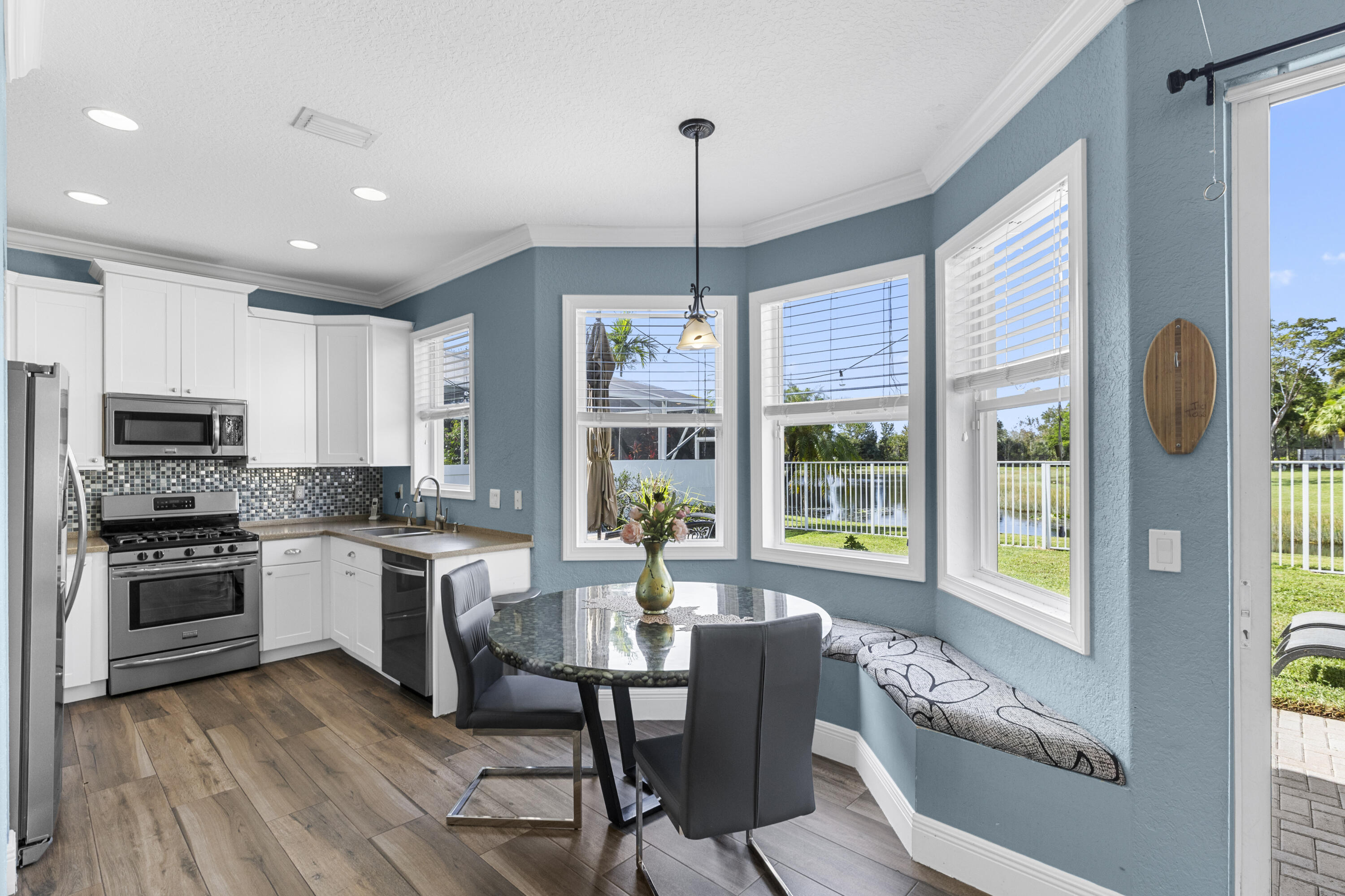 5791 Raceway Road Lake Worth, FL 33449 - Photo 16 of 62 a kitchen with microwave a stove and furniture