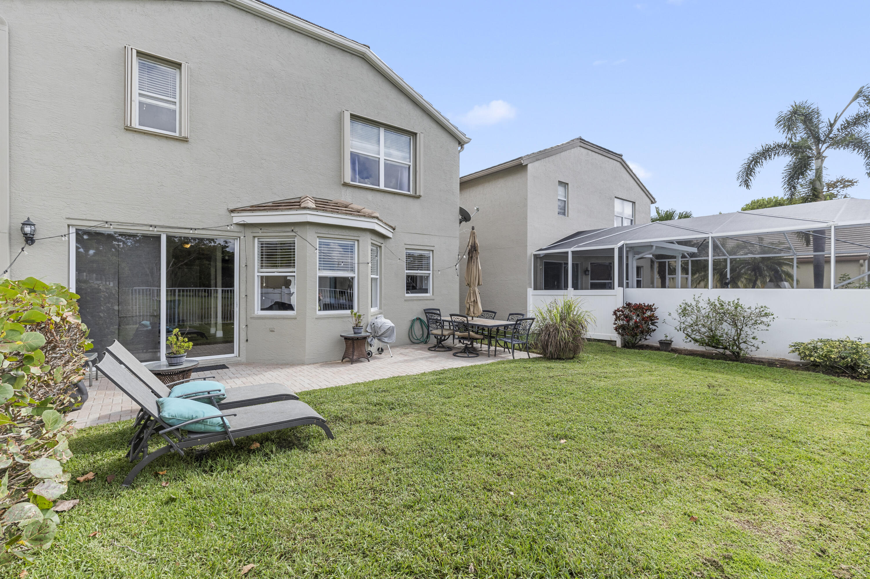 5791 Raceway Road Lake Worth, FL 33449 - Photo 49 of 62 a view of a house with a backyard porch and sitting area
