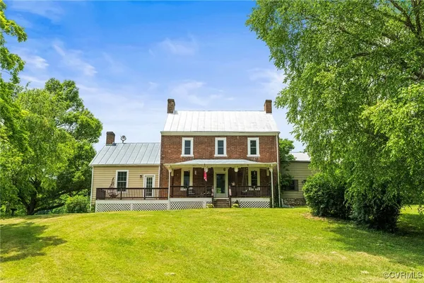 a view of an house with swimming pool and sitting area