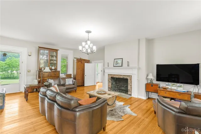 a living room with furniture flat screen tv and a fireplace