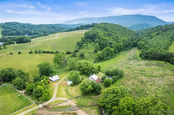 a view of a lush green hillside and houses