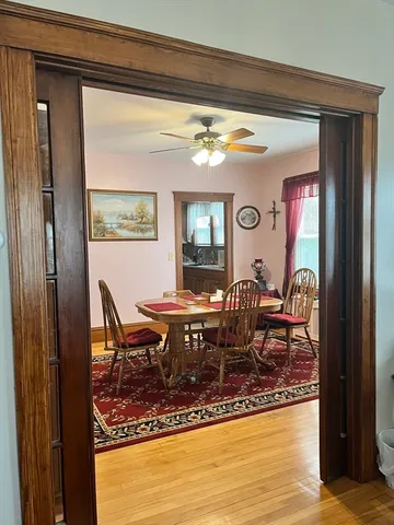 a view of a dining room with furniture window and wooden floor