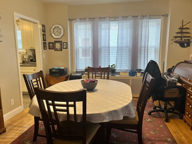 a view of a dining room with furniture and window