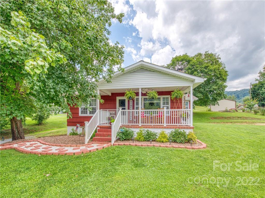 1239 Beaverdam Road Canton, NC 28716 - Photo 1 of 30 a front view of a house with a yard table and chairs