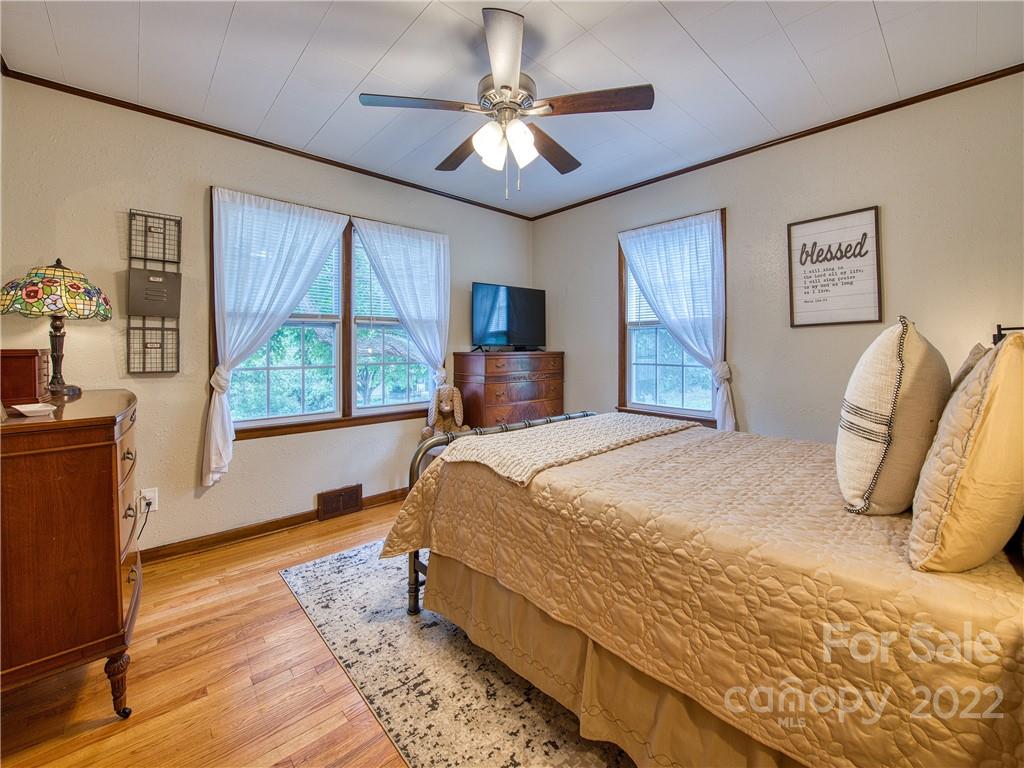 1239 Beaverdam Road Canton, NC 28716 - Photo 15 of 30 a bed sitting in a bedroom next to a window