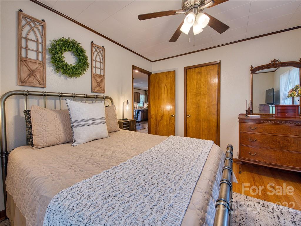 1239 Beaverdam Road Canton, NC 28716 - Photo 16 of 30 a bedroom with a bed and a chandelier