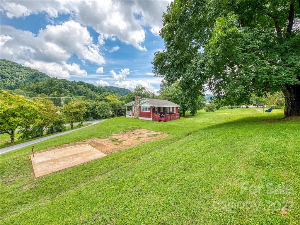 1239 Beaverdam Road Canton, NC 28716 - Photo 5 of 30 a view of a big yard with swimming pool and green space