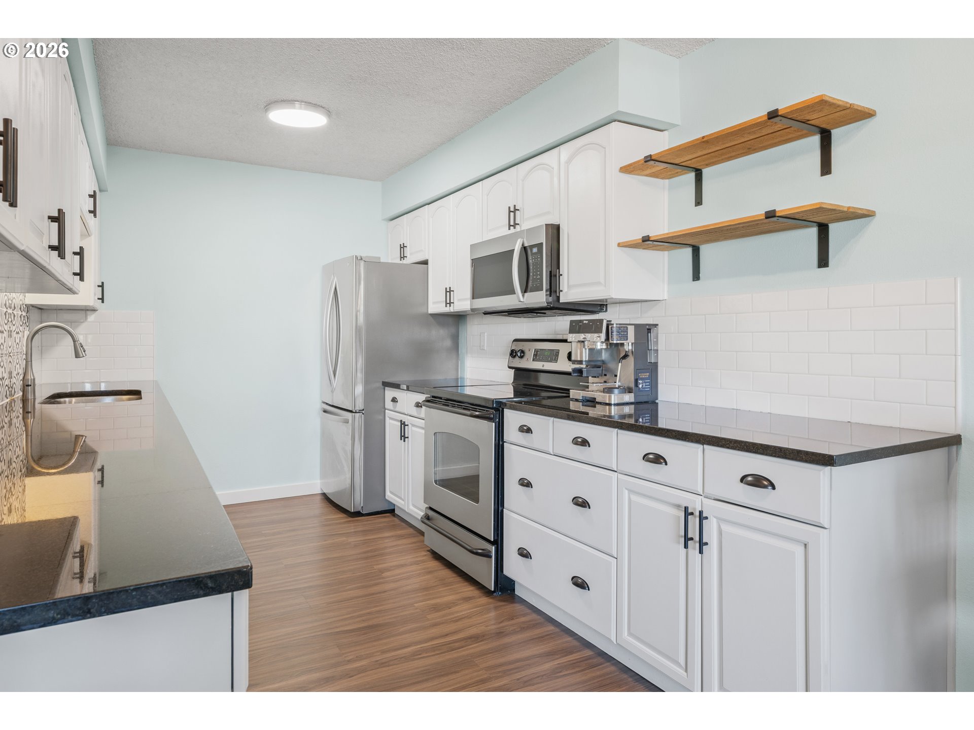 2727 Gateway Street, Unit 18 Springfield, OR 97477 - Photo 10 of 34 a kitchen with stainless steel appliances cabinets a sink and a stove