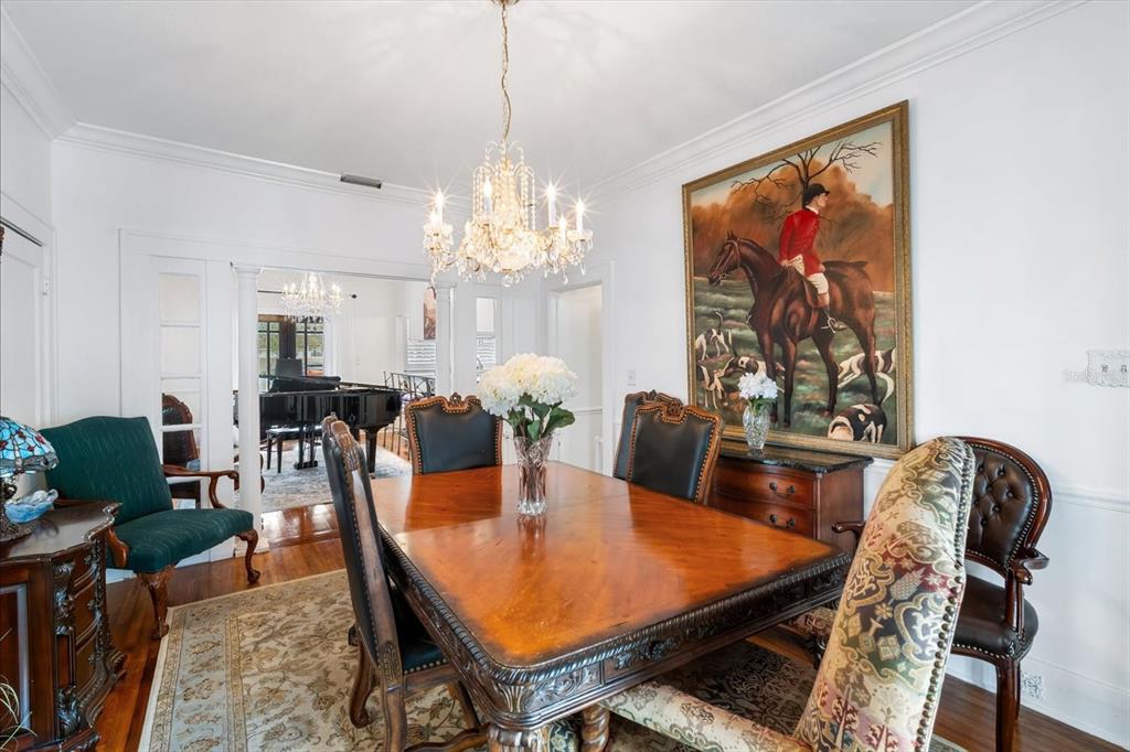 2402 North Ridgewood Avenue Tampa, FL 33602 - Photo 13 of 56 a view of a dining room with furniture a rug and wooden floor