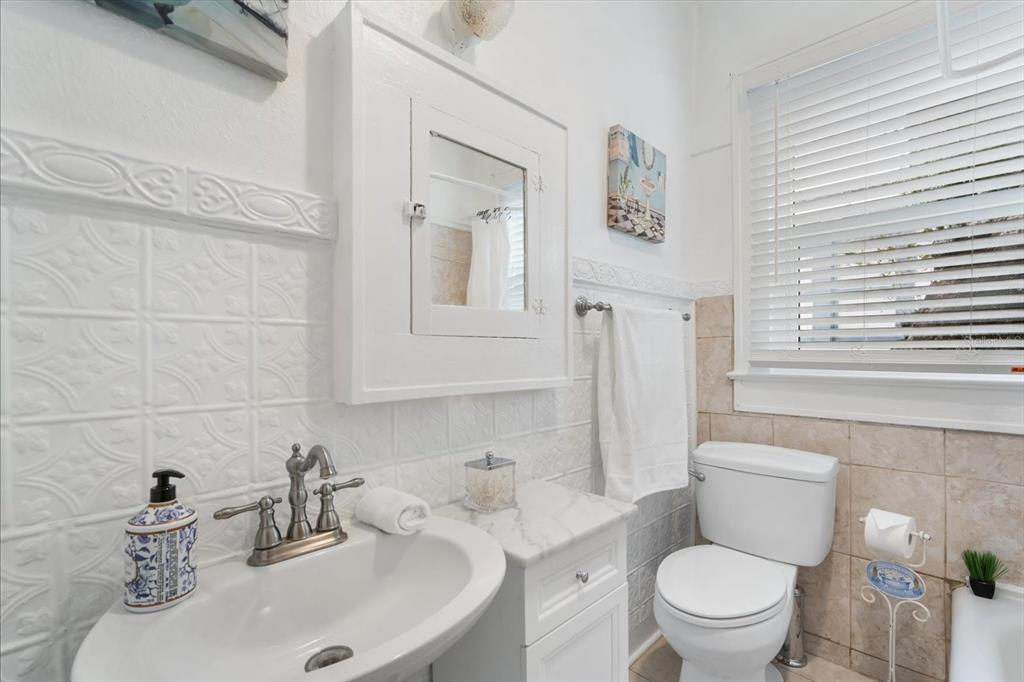 2402 North Ridgewood Avenue Tampa, FL 33602 - Photo 16 of 56 a bathroom with a sink a toilet and a mirror