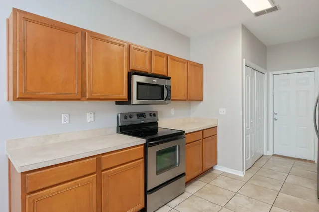 a kitchen with stainless steel appliances granite countertop a stove a microwave and a sink