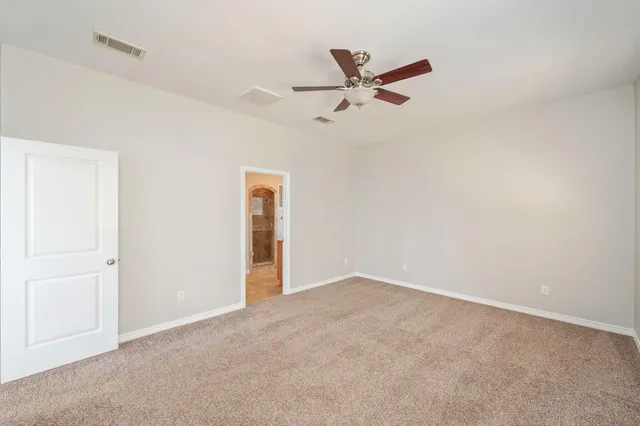 a view of a room with a ceiling fan