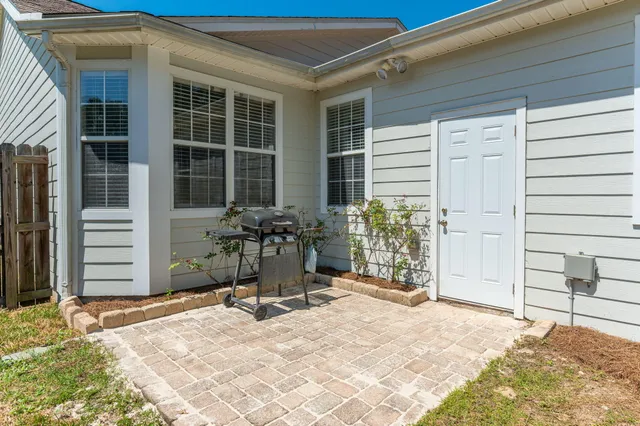 a view of a balcony with wooden floor and iron fence