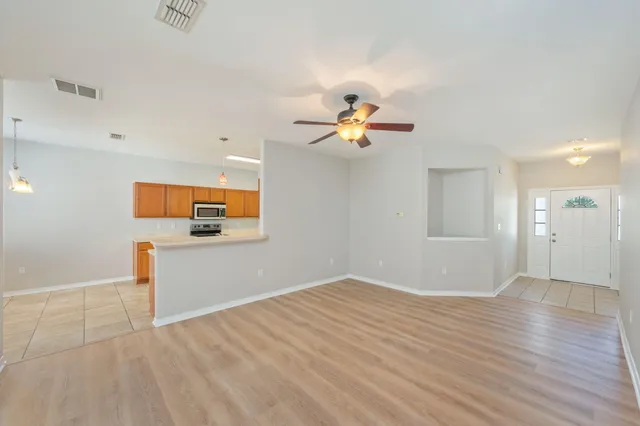 a view of empty room with wooden floor