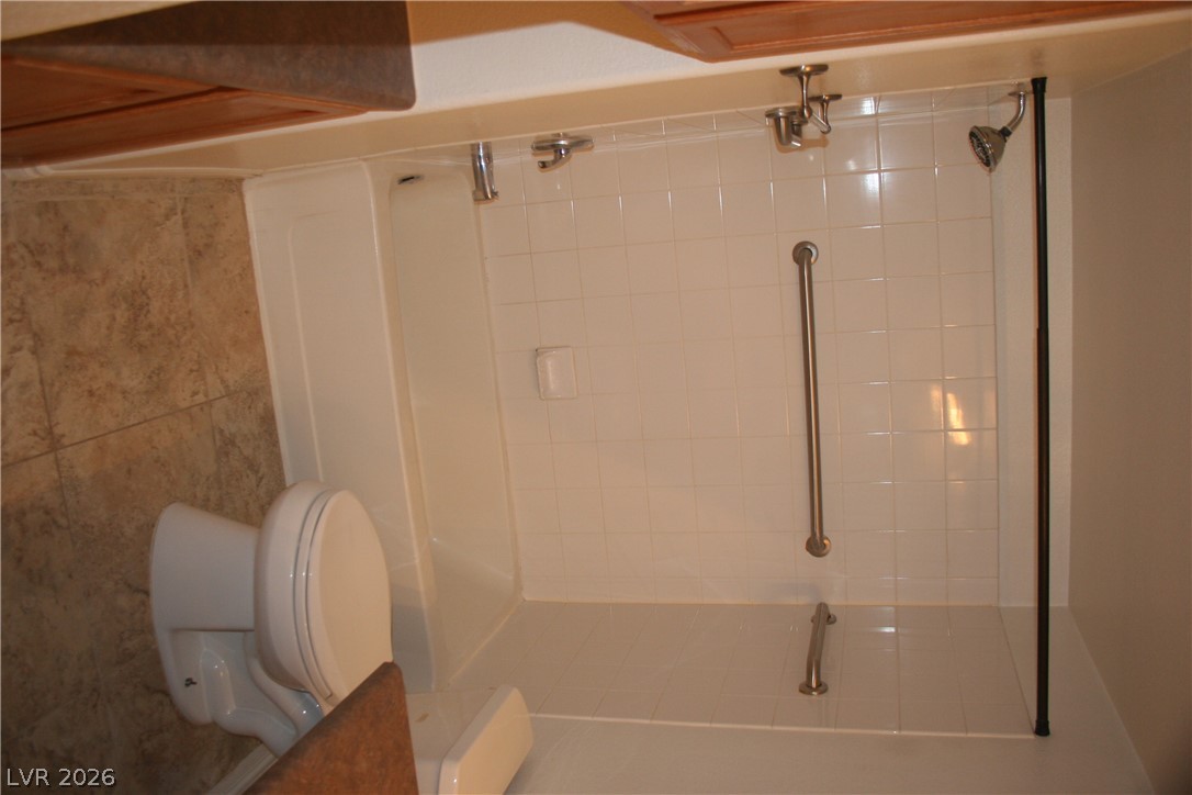 7255 West Sunset Road, Unit 1021 Las Vegas, NV 89113 - Photo 5 of 7 A classic tiled shower and tub combination anchors this functional bathroom space.
