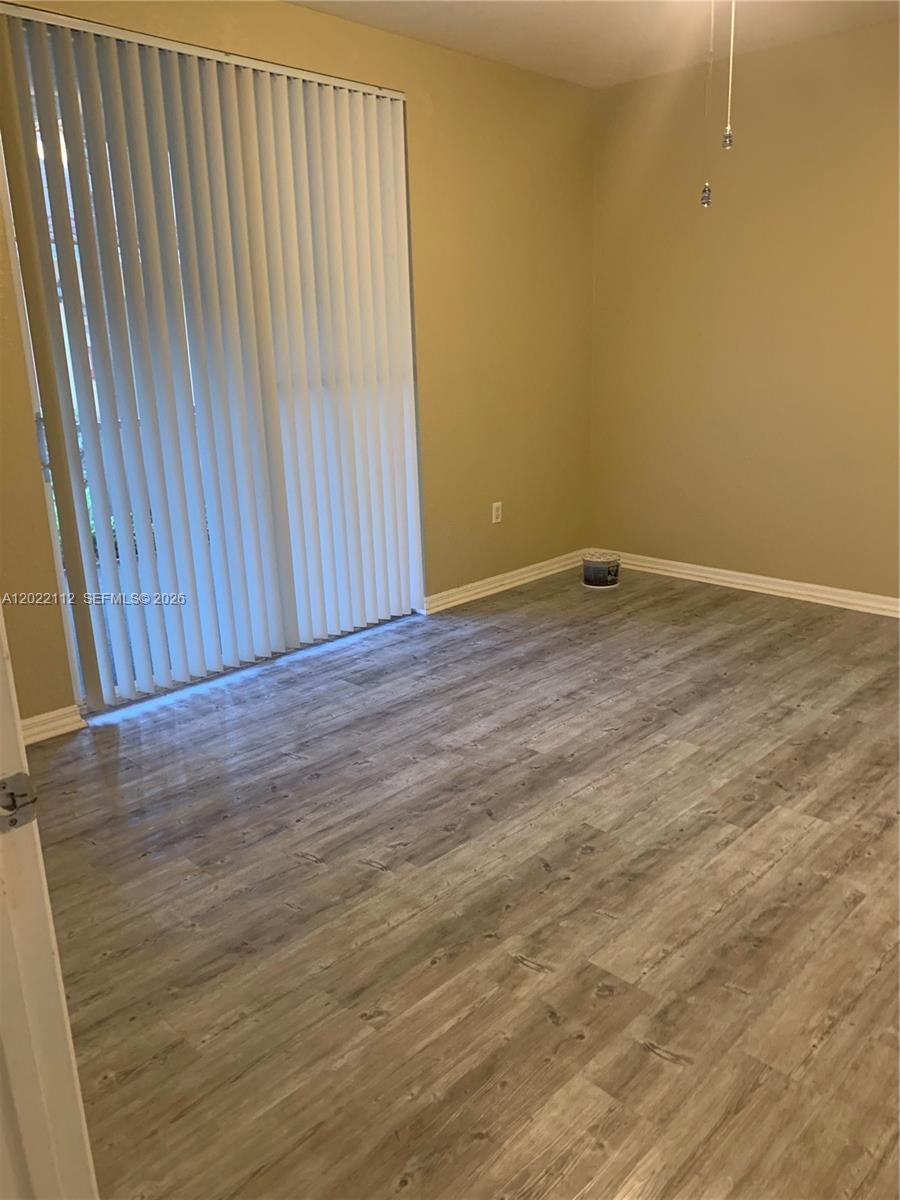 6572 West Sample Road, Unit 6572 Coral Springs, FL 33067 - Photo 9 of 17 a view of a room with wooden floor and a window