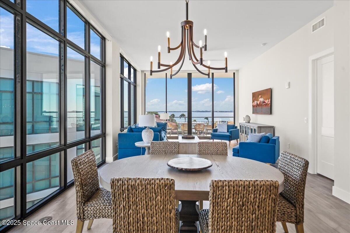 225 Strand Drive, Unit 401 Melbourne Beach, FL 32951 - Photo 11 of 51 a view of a dining room with furniture window and wooden floor