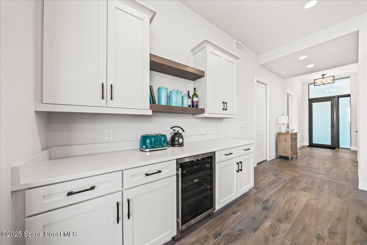 225 Strand Drive, Unit 401 Melbourne Beach, FL 32951 - Photo 13 of 51 a kitchen with stainless steel appliances granite countertop white cabinets a sink and dishwasher